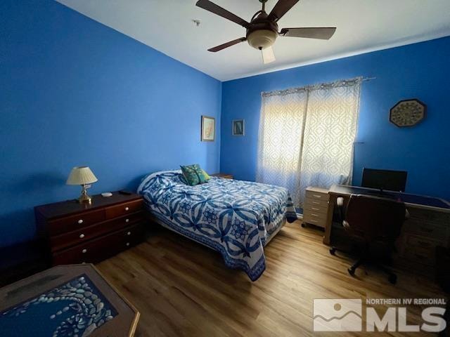 bedroom with ceiling fan and wood-type flooring