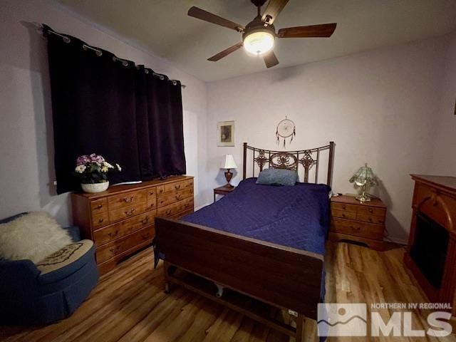 bedroom with hardwood / wood-style floors and ceiling fan