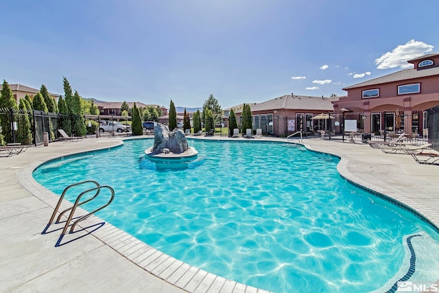 view of swimming pool featuring a patio area