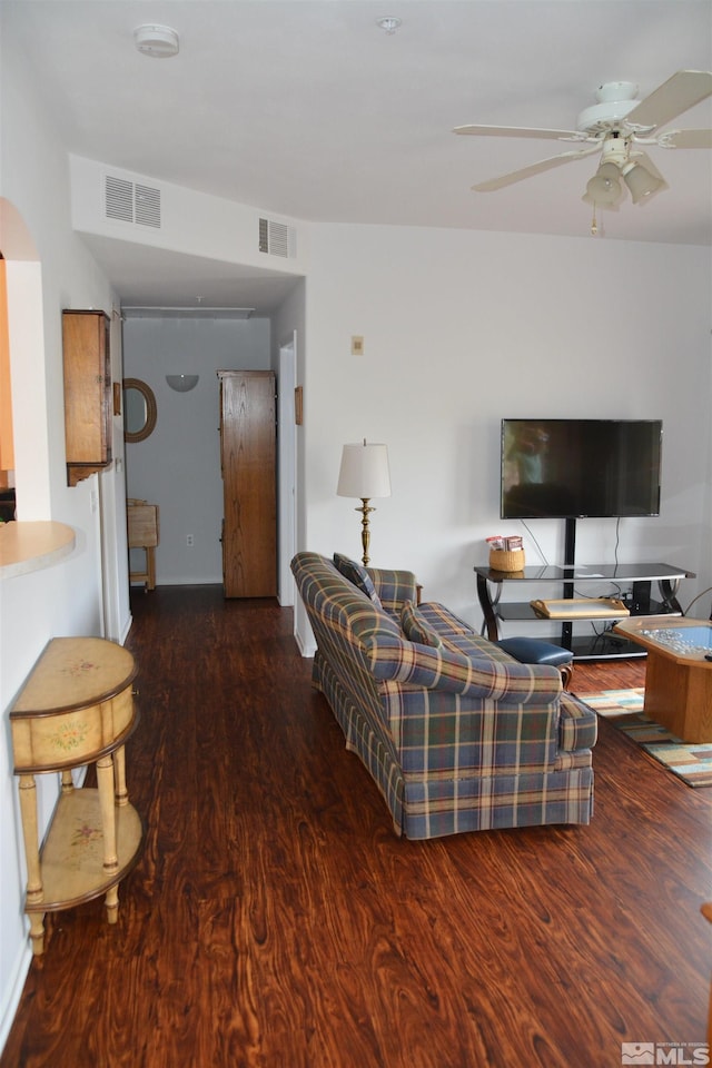 living room with ceiling fan and dark hardwood / wood-style flooring