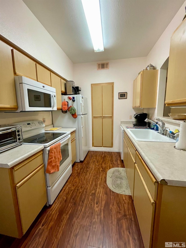 kitchen with light brown cabinets, white appliances, dark hardwood / wood-style floors, and sink