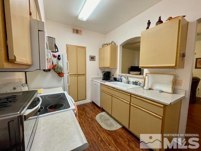 kitchen with dark hardwood / wood-style floors, stainless steel electric range oven, sink, and white dishwasher