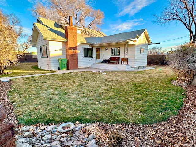 back of house featuring a patio area and a yard