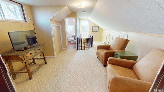 living area with light carpet and vaulted ceiling