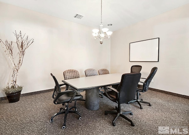 carpeted dining space featuring a notable chandelier