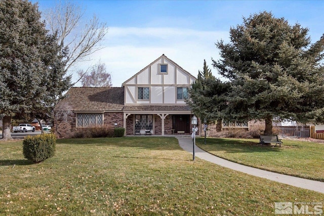 tudor home with a front lawn