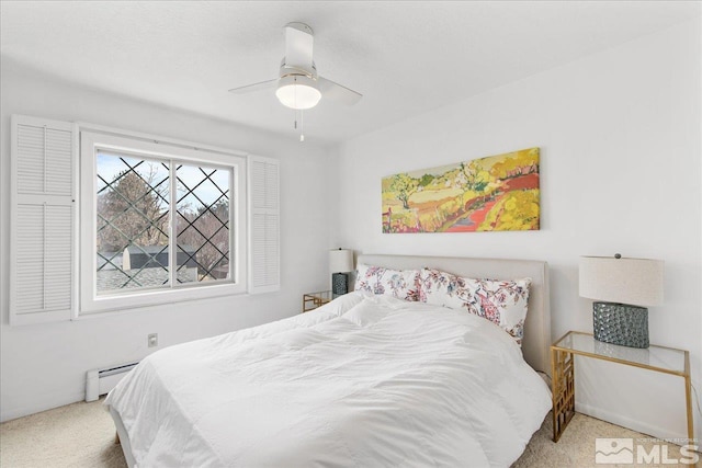 bedroom featuring a baseboard radiator, ceiling fan, and light carpet