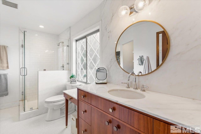 bathroom featuring tile floors, toilet, walk in shower, and vanity