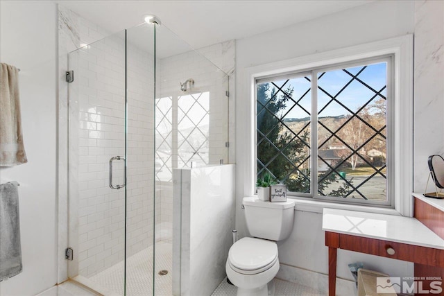 bathroom with walk in shower, tile floors, a healthy amount of sunlight, and toilet