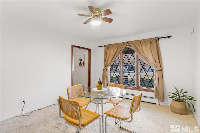 carpeted dining room featuring ceiling fan