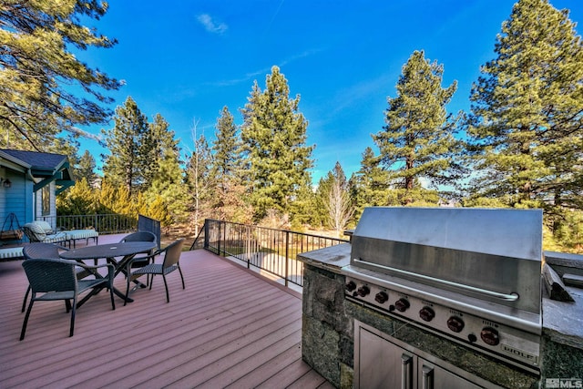 deck with grilling area and exterior kitchen