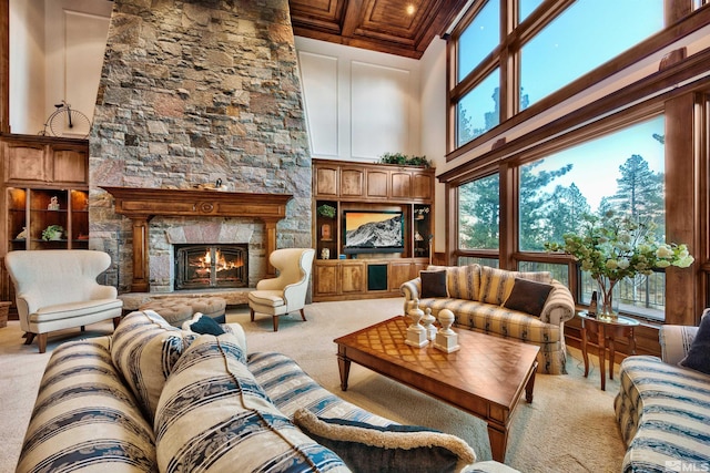 carpeted living room with a fireplace and a high ceiling