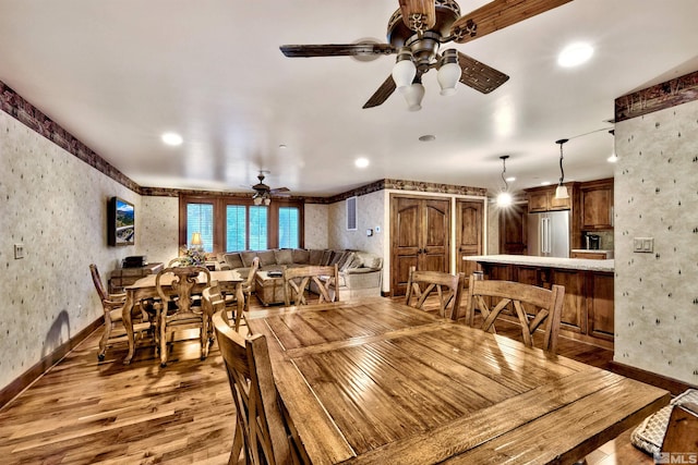 dining room featuring ceiling fan and dark wood-type flooring