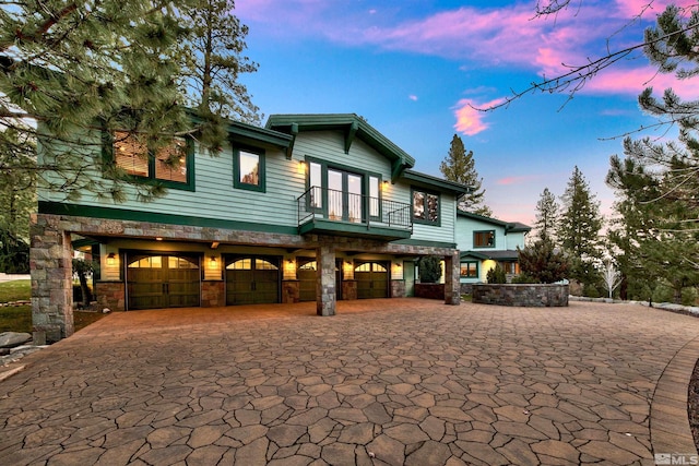 view of front of property with a balcony and a garage