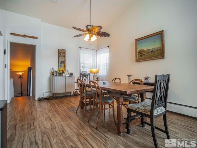 dining area with high vaulted ceiling, a baseboard radiator, ceiling fan, and dark wood-type flooring