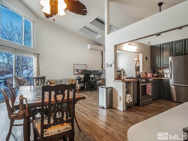 dining area with ceiling fan, high vaulted ceiling, and dark hardwood / wood-style floors