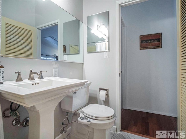 bathroom with hardwood / wood-style floors and toilet