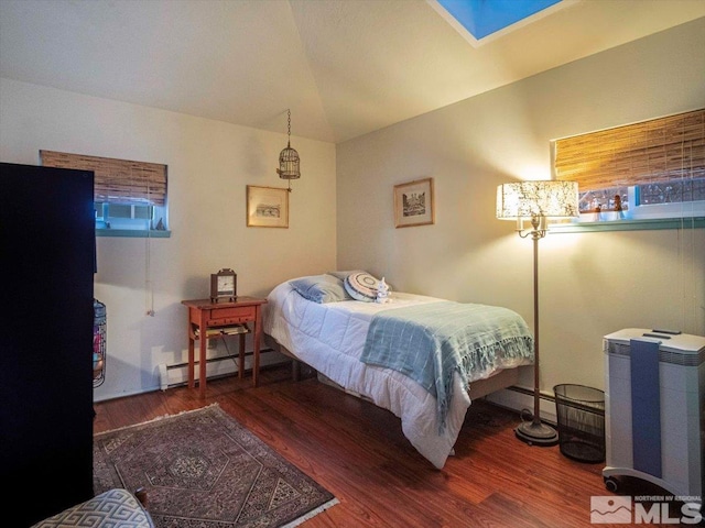 bedroom featuring dark hardwood / wood-style floors, a baseboard heating unit, and vaulted ceiling