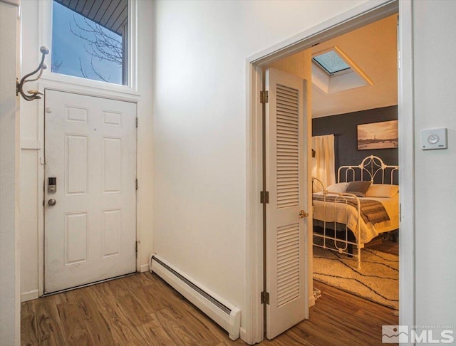 foyer featuring dark hardwood / wood-style floors and a baseboard heating unit