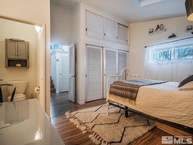 bedroom featuring dark wood-type flooring and a closet