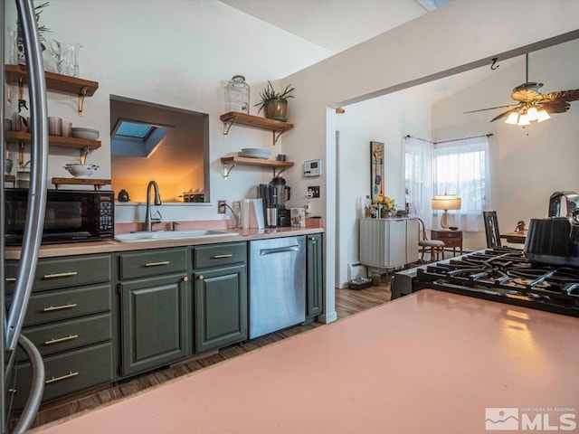 kitchen with ceiling fan, sink, dark hardwood / wood-style flooring, dishwasher, and vaulted ceiling