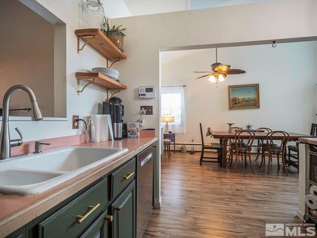 kitchen with lofted ceiling, dark wood-type flooring, ceiling fan, sink, and stainless steel dishwasher