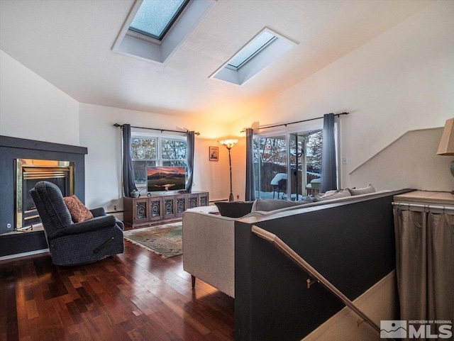 living room with dark hardwood / wood-style floors and lofted ceiling with skylight