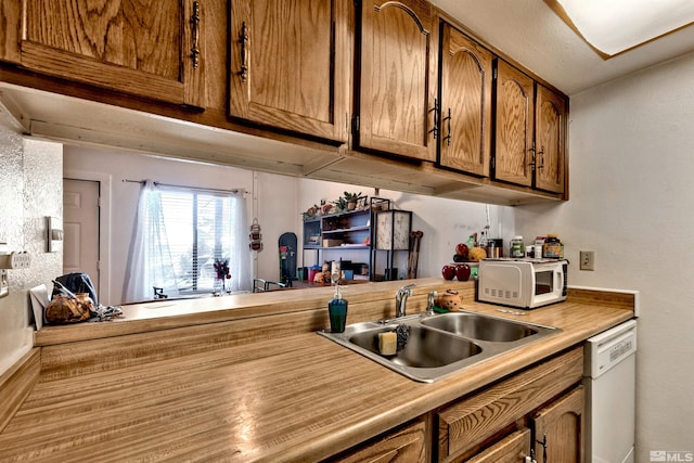 kitchen featuring sink and white appliances