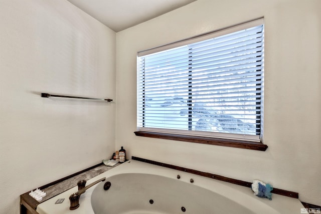 bathroom featuring a bath and a wealth of natural light