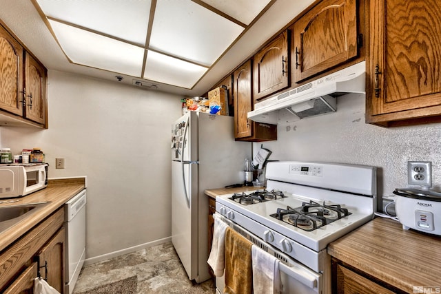 kitchen featuring white appliances and light tile flooring