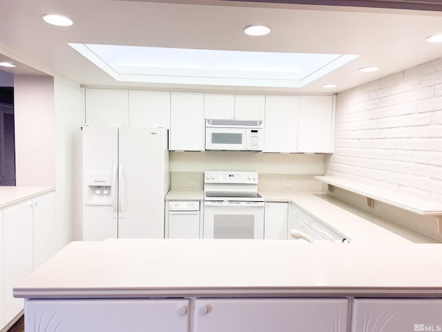 kitchen with white cabinets and white appliances