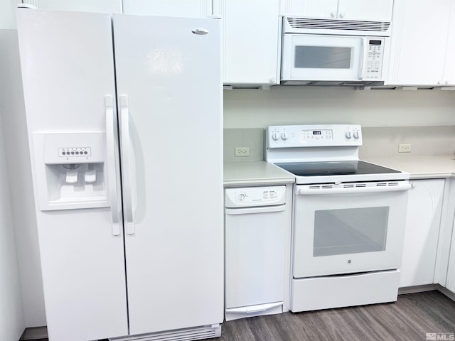 kitchen with white cabinetry, white appliances, and dark hardwood / wood-style floors