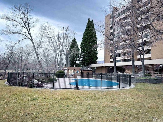 view of swimming pool with a patio area and a yard