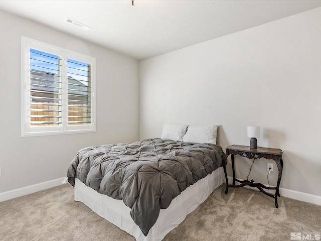 bedroom with light colored carpet