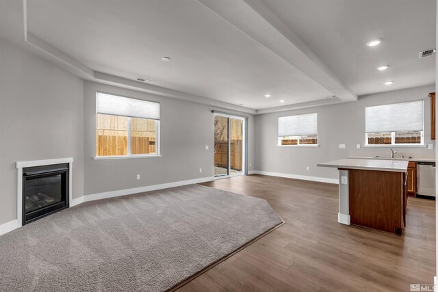 kitchen with hardwood / wood-style flooring, a kitchen island, and stainless steel appliances