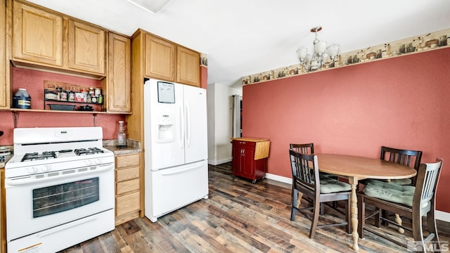 kitchen with a notable chandelier, white appliances, and dark wood-type flooring