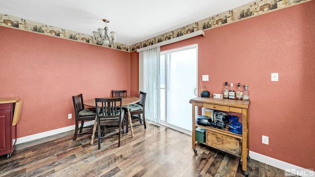 dining area with dark hardwood / wood-style floors and a chandelier