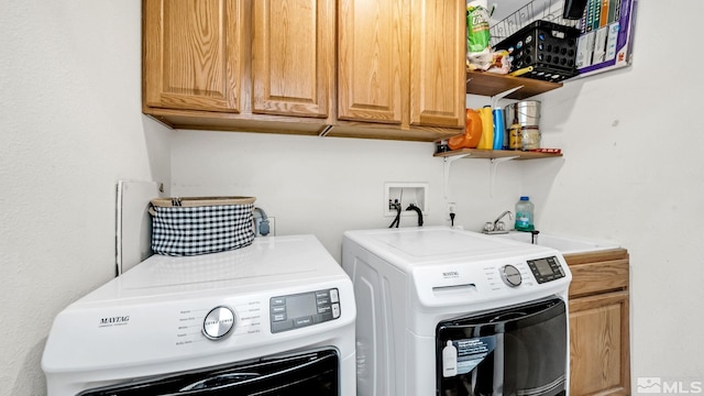 laundry area with washer hookup, sink, cabinets, and washing machine and dryer