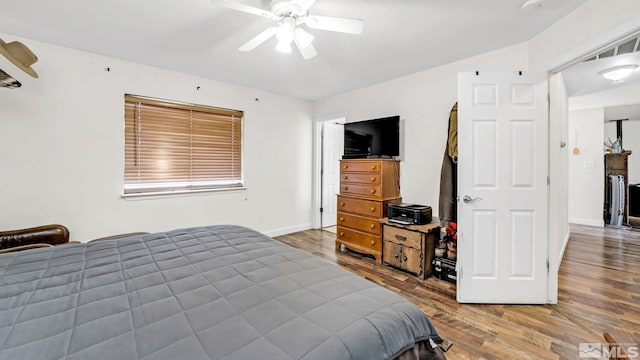 bedroom featuring ceiling fan and dark hardwood / wood-style floors