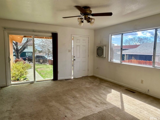 unfurnished room with ceiling fan and carpet floors