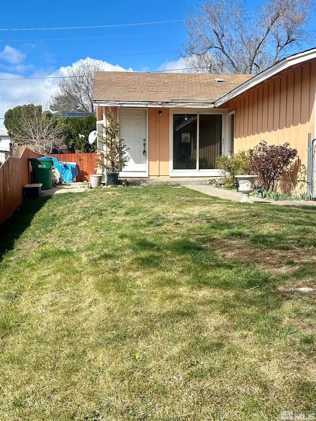 back of house with a lawn