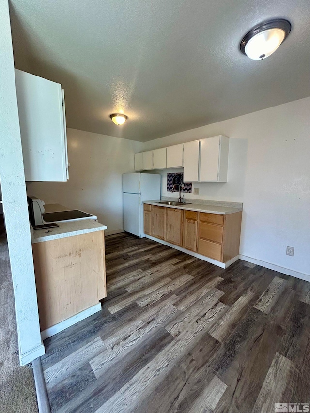 kitchen featuring range, a textured ceiling, sink, white refrigerator, and dark hardwood / wood-style floors