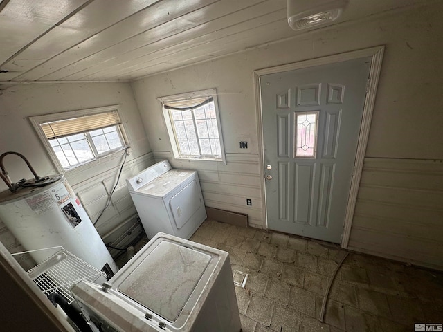 entrance foyer featuring lofted ceiling, washer and clothes dryer, and light tile floors