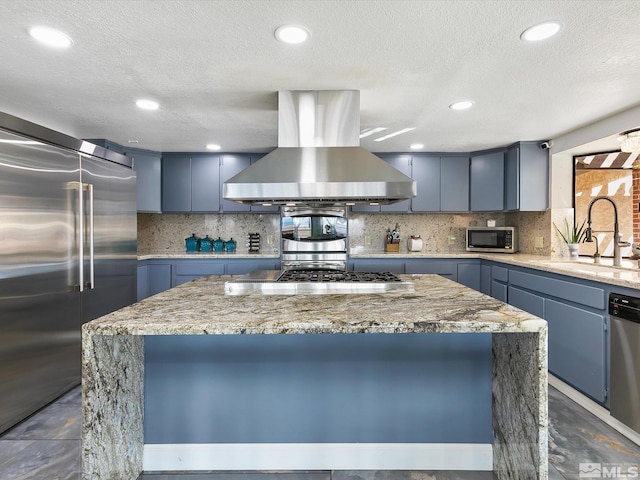 kitchen featuring appliances with stainless steel finishes, sink, a center island, tasteful backsplash, and island exhaust hood