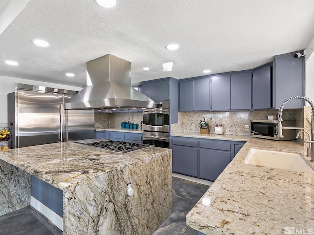 kitchen with appliances with stainless steel finishes, dark tile flooring, backsplash, and island exhaust hood