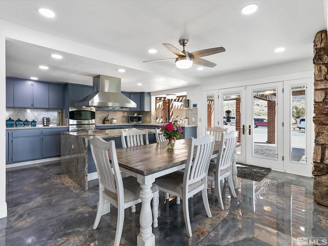 dining space featuring dark tile floors and ceiling fan