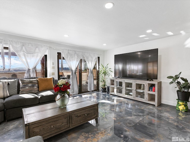 living room featuring dark tile floors and a textured ceiling