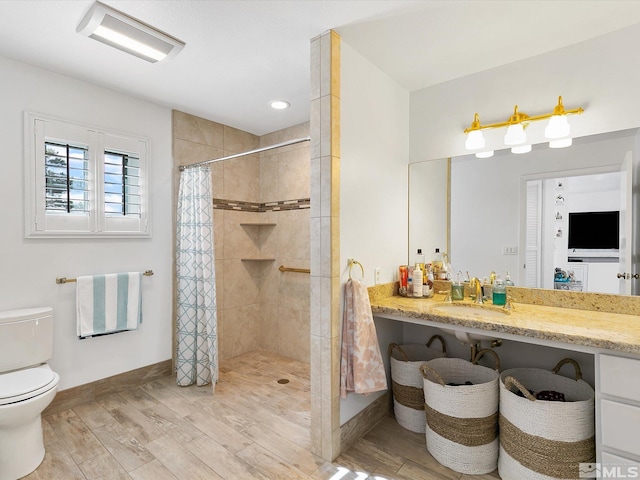 bathroom with hardwood / wood-style flooring, vanity, toilet, and walk in shower