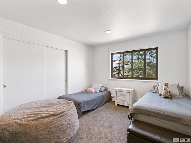 carpeted bedroom featuring a closet