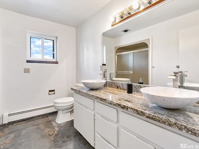 bathroom featuring toilet, vanity, and a baseboard radiator